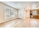 Bright living room with wood floors and a view of the kitchen at 1648 S Cole St # A2, Lakewood, CO 80228