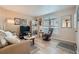 Inviting living room with neutral paint, wood flooring, and a large arched window at 1648 S Cole St # A2, Lakewood, CO 80228