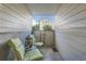 Enclosed patio featuring cozy seating area, decorative lantern, and view of the surrounding community at 1648 S Cole St # A2, Lakewood, CO 80228