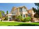 Spacious backyard with lush green lawn, covered patio and mature landscaping at 5773 S Benton Way, Littleton, CO 80123