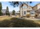 Expansive backyard featuring lush green grass, stone accents, and a covered patio area at 5773 S Benton Way, Littleton, CO 80123
