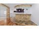 Finished basement with brick bar and decorative lighting at 5773 S Benton Way, Littleton, CO 80123