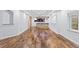 Finished basement with hardwood floors, a stone accent wall, and custom lighting at 5773 S Benton Way, Littleton, CO 80123