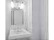 Bathroom with a pedestal sink and a large vanity mirror at 5773 S Benton Way, Littleton, CO 80123