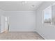 This bedroom offers a neutral palette, carpeted floors, and a large window that welcomes natural light at 5773 S Benton Way, Littleton, CO 80123