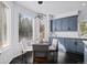 Breakfast nook with hardwood floors, modern lighting, and blue cabinets at 5773 S Benton Way, Littleton, CO 80123
