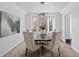 Dining room with a round table, modern lighting, and an adjacent doorway at 5773 S Benton Way, Littleton, CO 80123