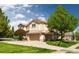 Suburban two-story home with an attached three car garage and a meticulously maintained yard at 5773 S Benton Way, Littleton, CO 80123