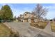 Suburban two-story home with a three-car garage and a circle driveway at 5773 S Benton Way, Littleton, CO 80123