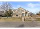 Inviting two-story home featuring a beautifully landscaped front yard with a charming water feature at 5773 S Benton Way, Littleton, CO 80123