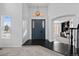 Entryway with blue front door, dark wood floors, and views of an adjacent study at 5773 S Benton Way, Littleton, CO 80123