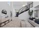Bright open foyer featuring a winding staircase, high ceilings, and stylish decor at 5773 S Benton Way, Littleton, CO 80123