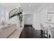 Open-concept home featuring a staircase, bar seating, and hardwood floors at 5773 S Benton Way, Littleton, CO 80123