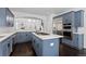 Spacious kitchen features an island cooktop, marble countertops, and stainless steel appliances at 5773 S Benton Way, Littleton, CO 80123