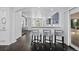Open concept kitchen with bar seating, modern countertops, and stainless steel appliances at 5773 S Benton Way, Littleton, CO 80123