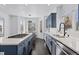 Kitchen with a large island, marble countertops, stainless steel appliances, and blue cabinets at 5773 S Benton Way, Littleton, CO 80123