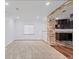 Spacious living room featuring stone accents, recessed lighting and open access to the kitchen at 5773 S Benton Way, Littleton, CO 80123