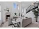 Open-concept living room with high ceilings, a fireplace, and a spiral staircase at 5773 S Benton Way, Littleton, CO 80123