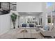 Bright living room with an open floor plan, staircase, and access to the kitchen area at 5773 S Benton Way, Littleton, CO 80123