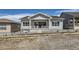 Back exterior of a gray single Gathering house with a small, landscaped backyard at 651 Scrubjay Cir, Castle Rock, CO 80104