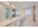 Bright Primary bathroom with double vanity, shower, and natural light at 651 Scrubjay Cir, Castle Rock, CO 80104