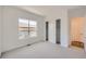 Bright bedroom with a window, carpet, and white walls, and sliding door closet at 651 Scrubjay Cir, Castle Rock, CO 80104
