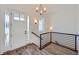 Bright entryway with hardwood floors, a stylish staircase, and a modern chandelier at 651 Scrubjay Cir, Castle Rock, CO 80104