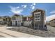 Beautiful home with gray stone and siding, complemented by a two-car garage and manicured landscaping at 651 Scrubjay Cir, Castle Rock, CO 80104