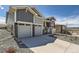 Attractive two-story home showcasing stone accents, two-car garage, and well-maintained landscaping at 651 Scrubjay Cir, Castle Rock, CO 80104