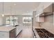 Bright kitchen with stainless steel appliances, island, and views of the backyard at 651 Scrubjay Cir, Castle Rock, CO 80104