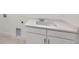 Close up of a white laundry sink with white cabinets and light countertop at 651 Scrubjay Cir, Castle Rock, CO 80104