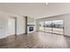 Open living room featuring wood floors, a cozy fireplace, and a sliding door to the outside at 651 Scrubjay Cir, Castle Rock, CO 80104