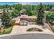 Aerial view of a two-story house with a spacious driveway and a well-maintained, lush green yard at 2380 W 105Th Pl, Northglenn, CO 80234