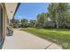 Spacious backyard with lawn, greenery, mature trees, and patio space at 2380 W 105Th Pl, Northglenn, CO 80234