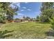 Large backyard featuring manicured lawn and privacy landscaping with mature trees at 2380 W 105Th Pl, Northglenn, CO 80234