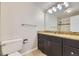 Bathroom showcasing vanity with granite counters and tiled shower at 2380 W 105Th Pl, Northglenn, CO 80234