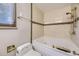 Well-lit bathroom features a bathtub, a shower, and tiled walls adding a touch of luxury at 2380 W 105Th Pl, Northglenn, CO 80234