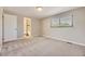 Well-lit bedroom featuring a window and an adjacent bathroom at 2380 W 105Th Pl, Northglenn, CO 80234