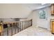 Hallway with wood railing overlooking the living room and a white door leading outside at 2380 W 105Th Pl, Northglenn, CO 80234