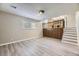 Bright living room adjacent to the kitchen, featuring new floors and stairs at 2380 W 105Th Pl, Northglenn, CO 80234