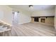 Spacious living room with a classic brick fireplace and modern flooring, offering a versatile layout for various furniture arrangements at 2380 W 105Th Pl, Northglenn, CO 80234