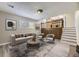 Comfortable living room with stairs, features a stylish brick fireplace and seamlessly connects to the open kitchen area at 2380 W 105Th Pl, Northglenn, CO 80234