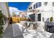 Beautiful backyard with a raised patio, white gravel landscaping, and privacy fencing at 619 S Gilpin St, Denver, CO 80209