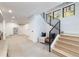 Finished basement features an open layout with a staircase and modern black metal railing at 619 S Gilpin St, Denver, CO 80209