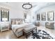 Bright bedroom featuring hardwood floors, neutral colors, and a modern chandelier at 619 S Gilpin St, Denver, CO 80209