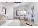 Bright bedroom featuring hardwood floors, neutral colors, and a seating area at 619 S Gilpin St, Denver, CO 80209