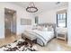 Bright bedroom featuring hardwood floors, neutral colors, and a statement rug at 619 S Gilpin St, Denver, CO 80209