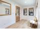 Bright entryway with wood floors, large mirror, and a cozy bench at 619 S Gilpin St, Denver, CO 80209