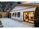 The garage has a modern exterior with white siding, black trim, and an adjacent gravel area at 619 S Gilpin St, Denver, CO 80209
