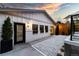The building features white siding, black trim, and a gravel landscape with a door leading into the backyard at 619 S Gilpin St, Denver, CO 80209